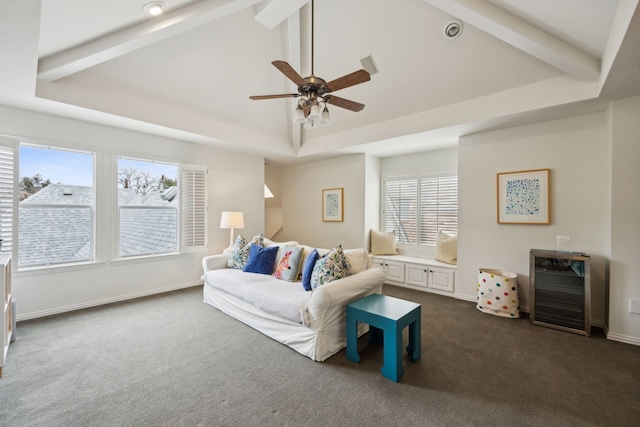 living area with vaulted ceiling with beams, a tray ceiling, dark carpet, and baseboards