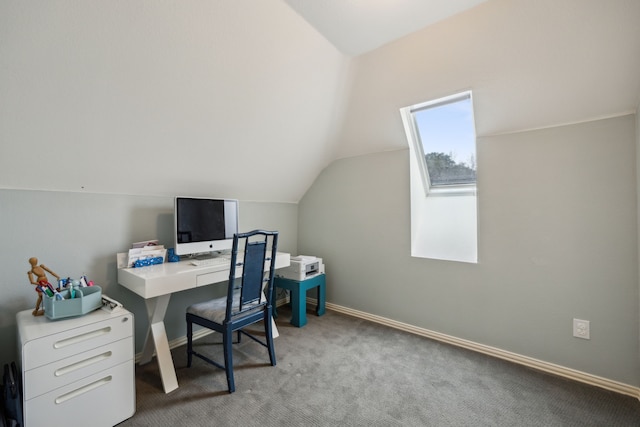 office space featuring lofted ceiling, light carpet, and baseboards