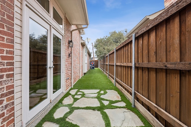 exterior space featuring fence private yard and french doors