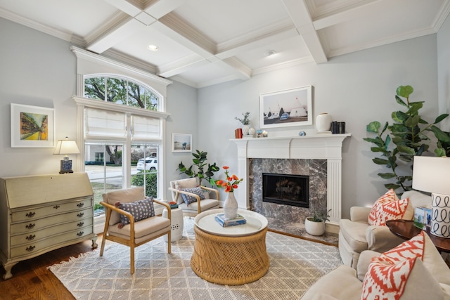 living room with beamed ceiling, coffered ceiling, wood finished floors, and a high end fireplace