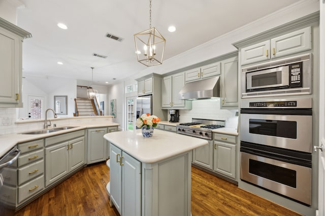 kitchen featuring under cabinet range hood, visible vents, light countertops, and gray cabinetry