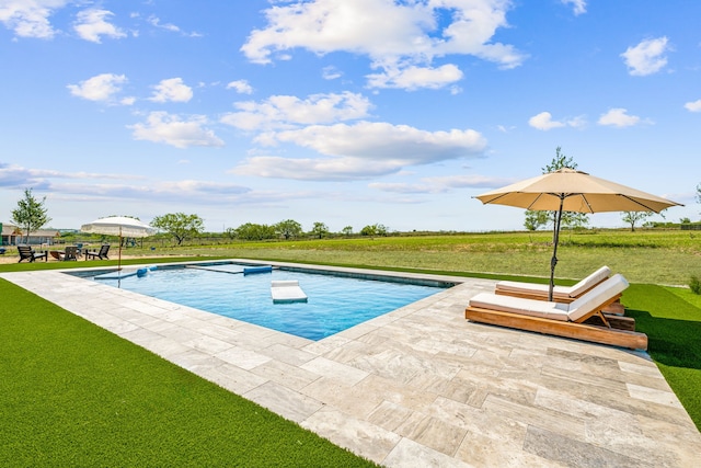 pool with a yard and a patio