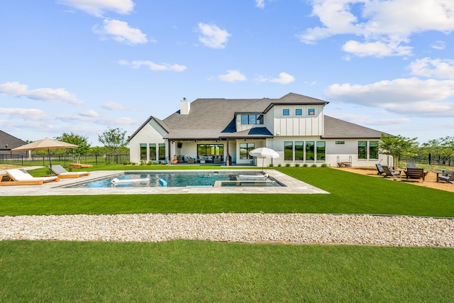 rear view of property featuring a patio, fence, a lawn, a fenced in pool, and board and batten siding