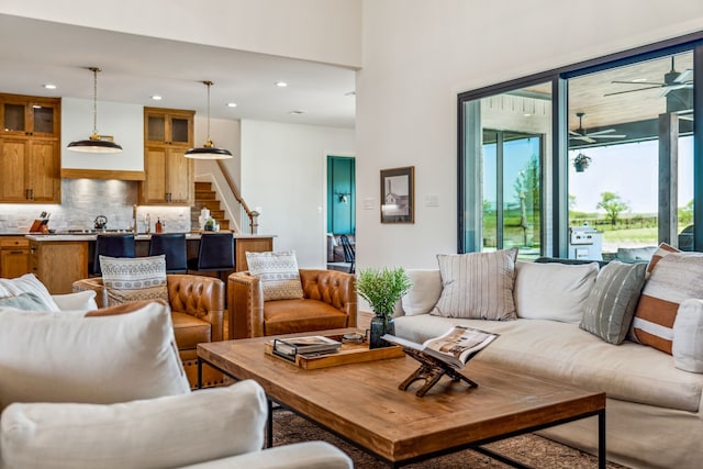 living area featuring ceiling fan, stairway, and recessed lighting