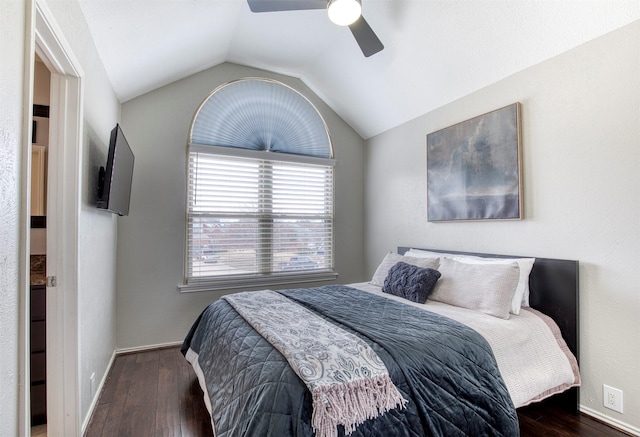 bedroom with lofted ceiling, ceiling fan, dark wood finished floors, and baseboards