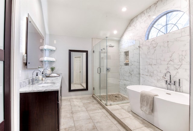 bathroom featuring double vanity, recessed lighting, a stall shower, a sink, and a freestanding tub