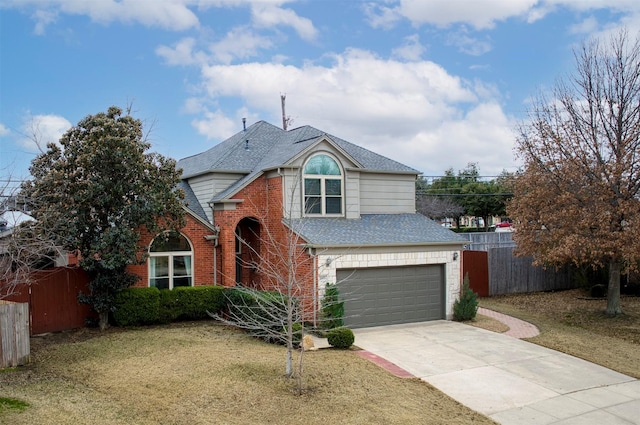 traditional-style house featuring roof with shingles, brick siding, fence, a garage, and a front lawn