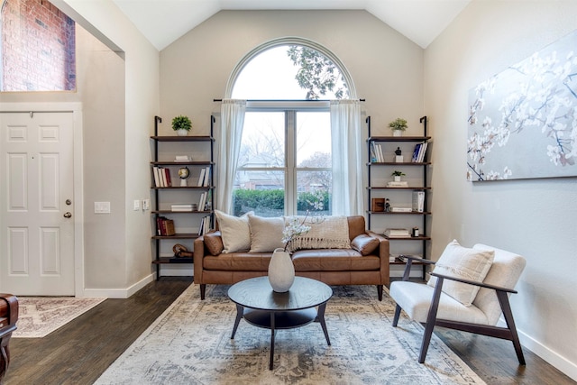 sitting room with vaulted ceiling, dark wood-type flooring, and a healthy amount of sunlight