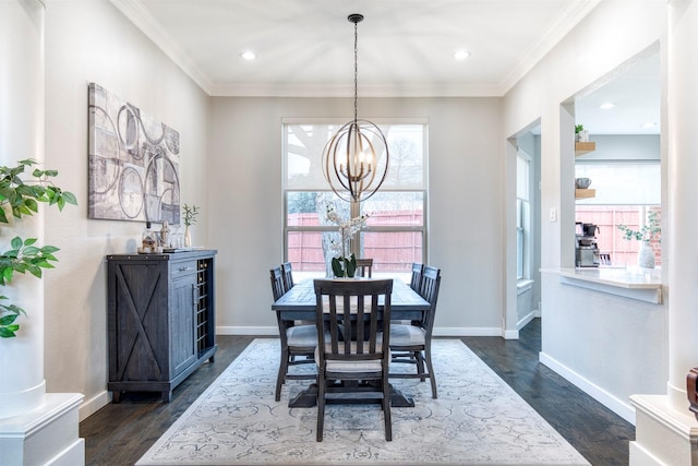 dining room with dark wood-style floors, crown molding, and baseboards