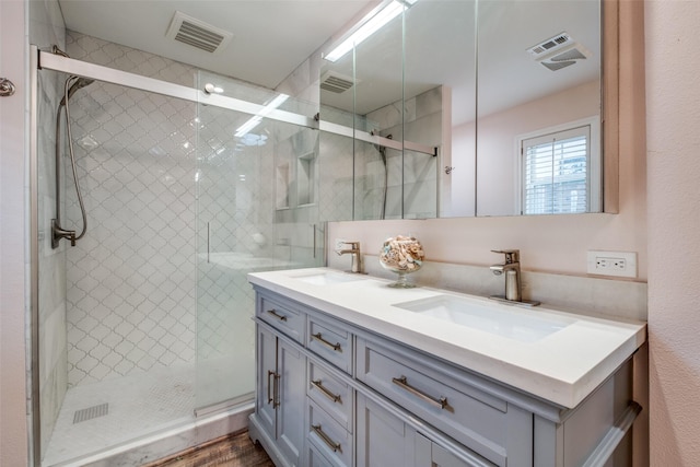 full bathroom featuring visible vents, a sink, and double vanity