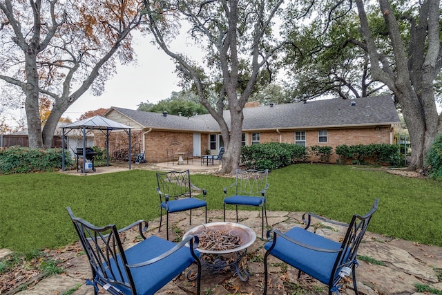 view of patio with an outdoor fire pit and a gazebo