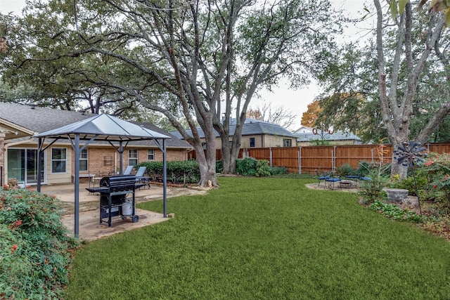 view of yard featuring a patio area, fence, and a gazebo