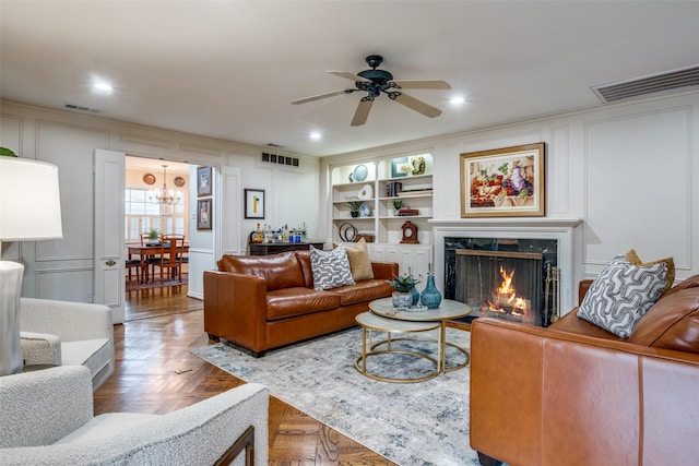 living area with a fireplace, visible vents, and a decorative wall