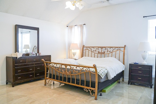 bedroom with ceiling fan, multiple windows, and vaulted ceiling