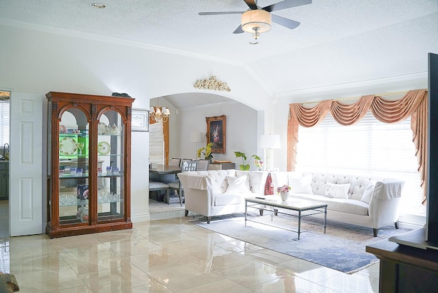 living room featuring a textured ceiling, arched walkways, vaulted ceiling, marble finish floor, and crown molding