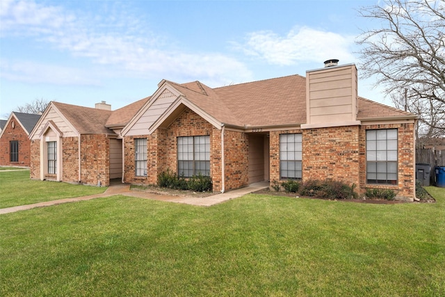 ranch-style home featuring brick siding, a chimney, and a front lawn