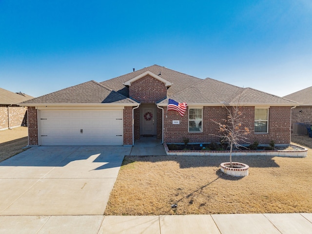 ranch-style home with an outdoor fire pit, brick siding, and driveway