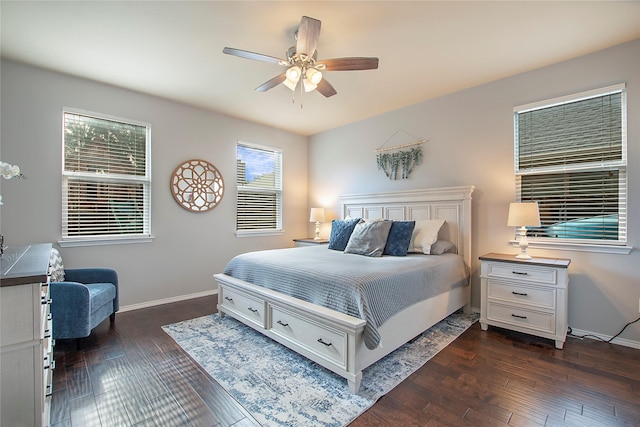 bedroom featuring ceiling fan, baseboards, and dark wood finished floors