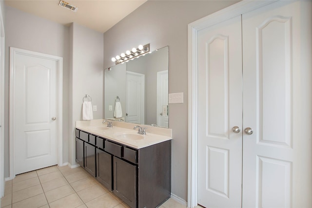 bathroom with double vanity, tile patterned flooring, visible vents, and a sink