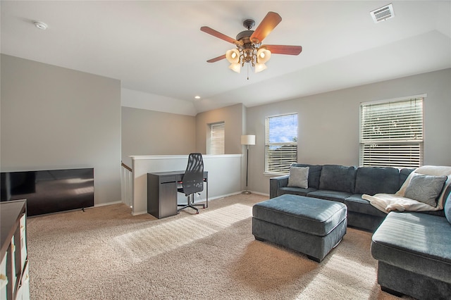 living area featuring visible vents, vaulted ceiling, light carpet, and baseboards