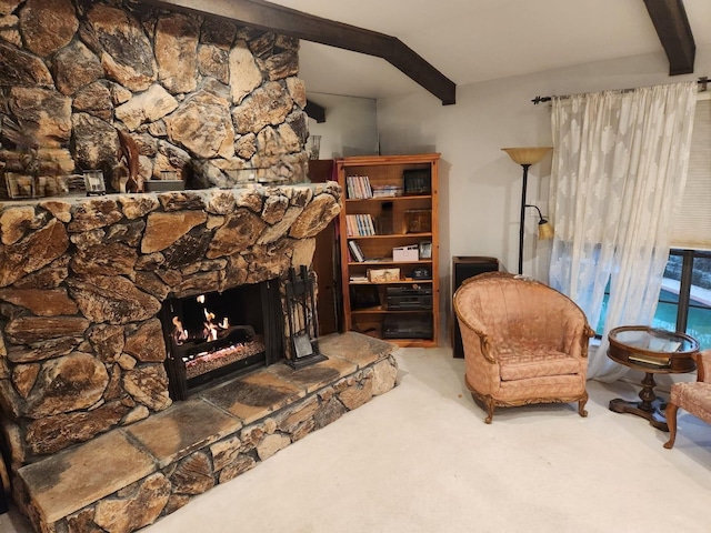 sitting room featuring beamed ceiling, a fireplace, and carpet flooring