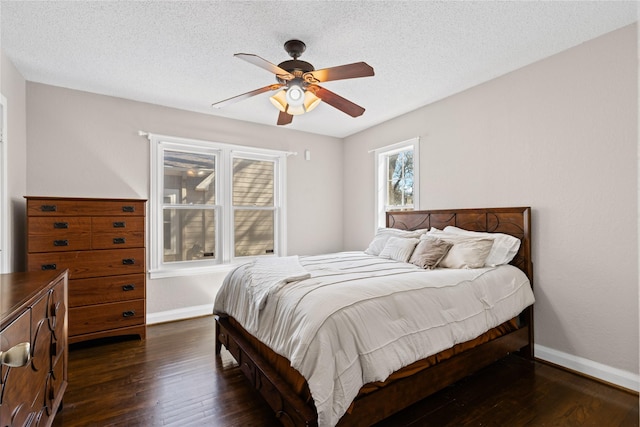 bedroom with dark wood-style floors, ceiling fan, a textured ceiling, and baseboards