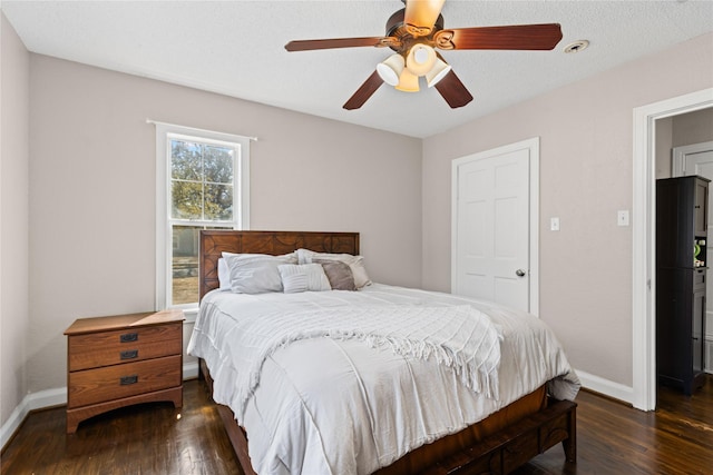 bedroom with dark wood-style floors, ceiling fan, and baseboards