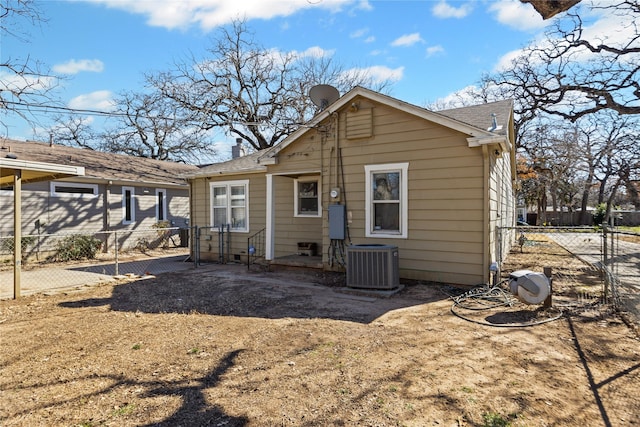 rear view of house featuring fence and central AC unit