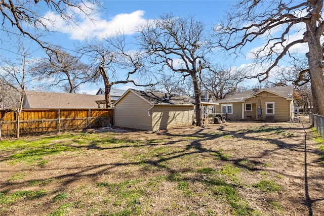 view of yard featuring an outbuilding, a storage shed, and a fenced backyard