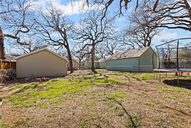 view of yard featuring a trampoline and a fenced backyard