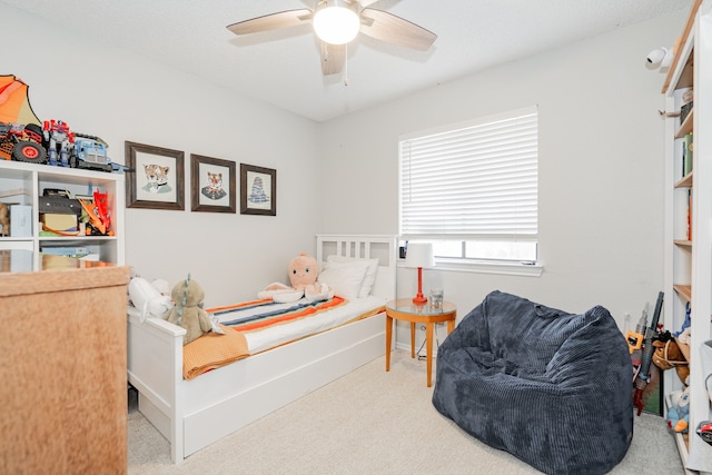 bedroom featuring light carpet and ceiling fan