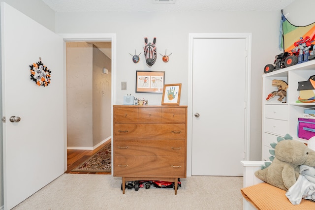 bedroom featuring light carpet