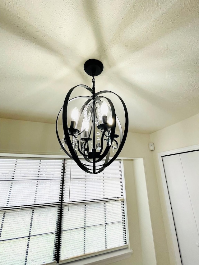 room details with a textured ceiling and a notable chandelier