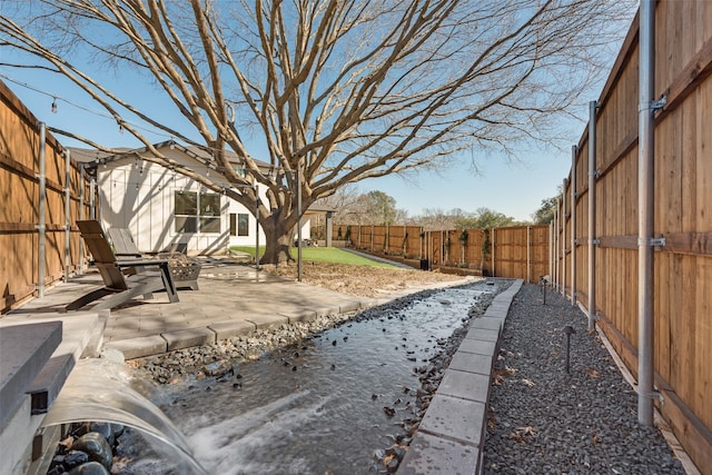 view of yard featuring a patio area and a fenced backyard