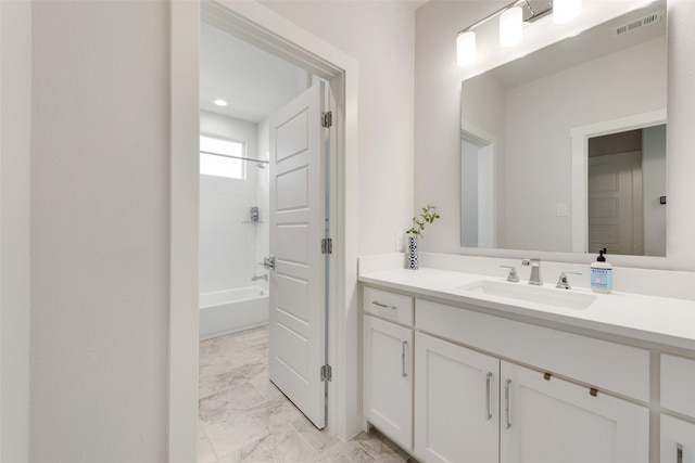 bathroom with marble finish floor, visible vents, tub / shower combination, and vanity