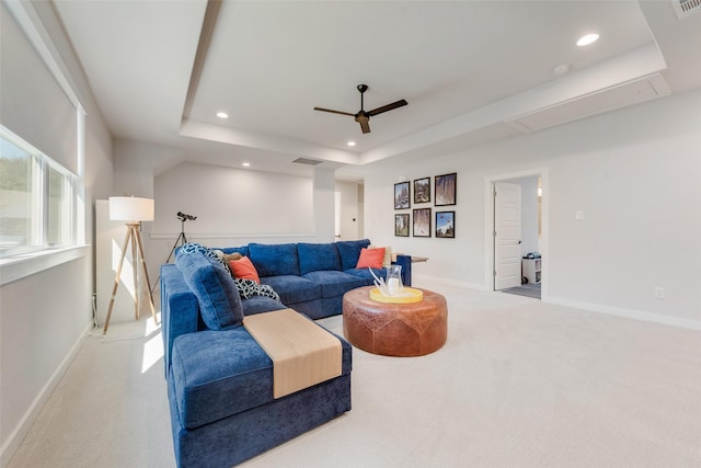 carpeted living room with attic access, recessed lighting, a raised ceiling, and baseboards