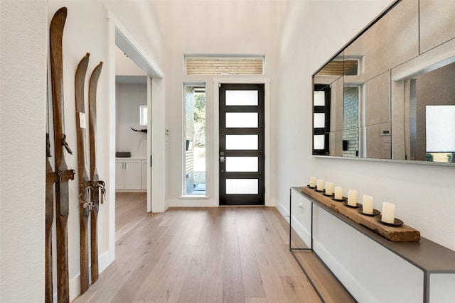 entryway featuring light wood-style flooring and baseboards