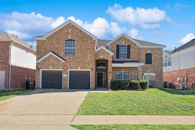 traditional-style home with brick siding, concrete driveway, an attached garage, central air condition unit, and a front yard