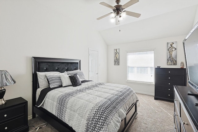 bedroom featuring light carpet, vaulted ceiling, a ceiling fan, and baseboards