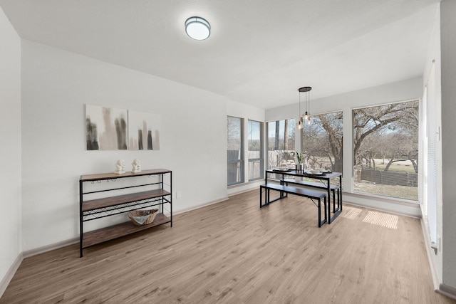 dining room with light wood-style floors and baseboards