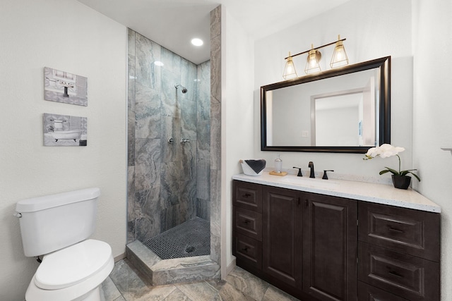 full bath with a stall shower, vanity, and toilet