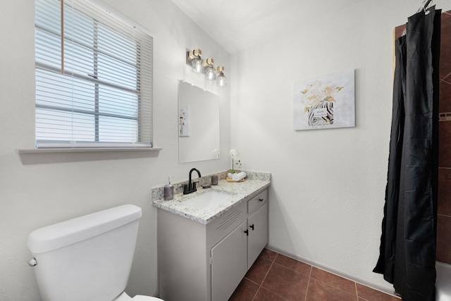 bathroom featuring toilet, vanity, and tile patterned floors