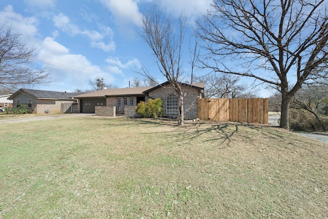 view of front facade with concrete driveway, an attached garage, a gate, fence, and a front yard