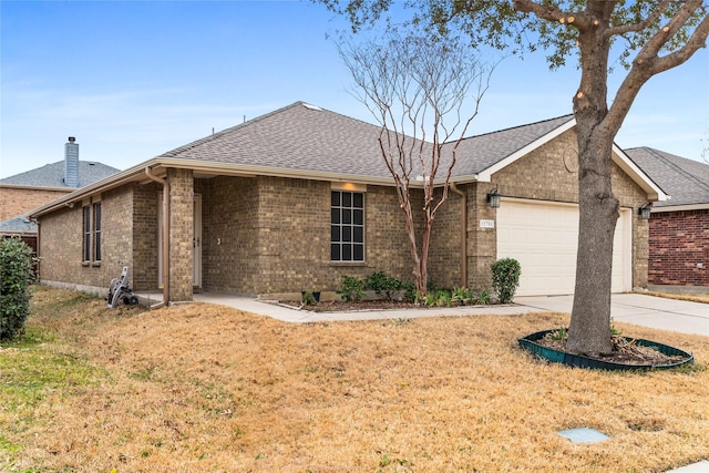 single story home with a shingled roof, a front yard, driveway, and an attached garage