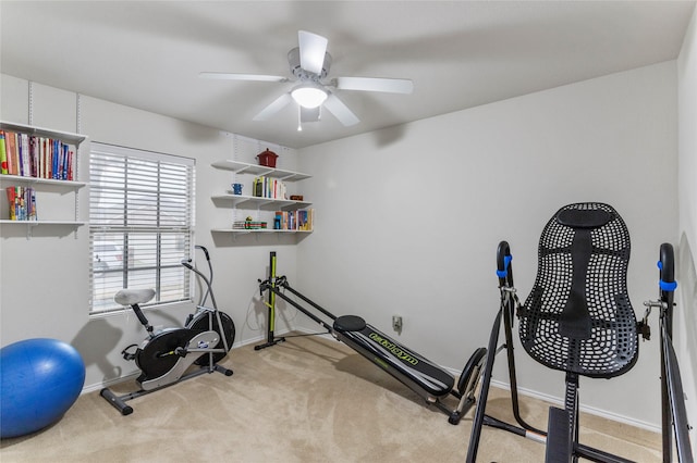 exercise room with a ceiling fan, carpet flooring, and baseboards