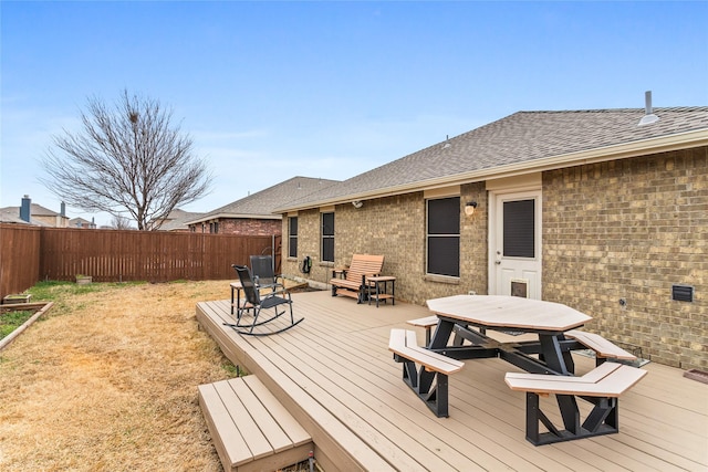 wooden terrace featuring outdoor dining area and fence