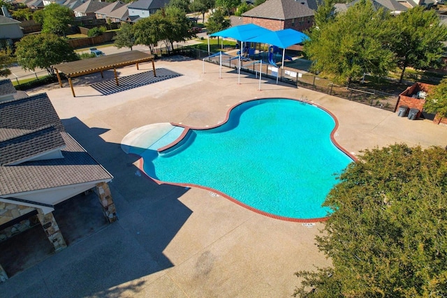 pool with fence and a patio