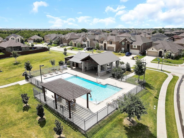 community pool featuring a yard, a gazebo, a patio area, fence, and a residential view