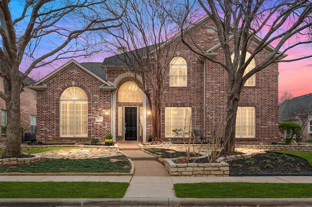 traditional-style house with brick siding