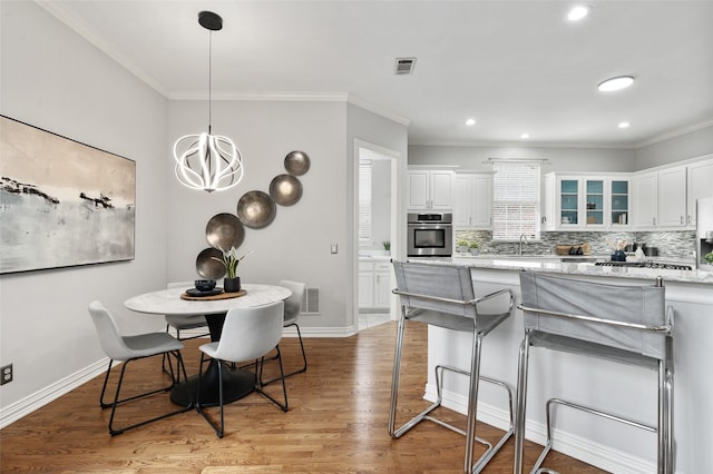 kitchen featuring visible vents, glass insert cabinets, white cabinets, light stone countertops, and oven